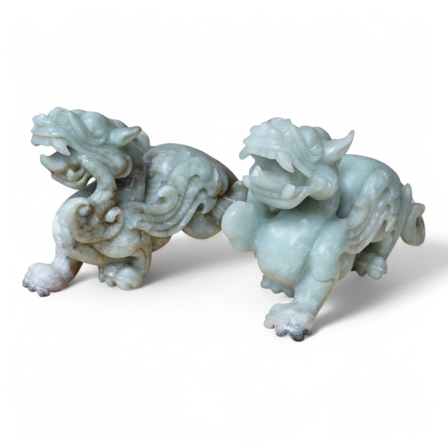 A pair of carved Chinese bowenite jade dragons, 28cm wide. Condition - fair